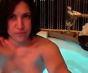 Amateur couple having sex in the green jacuzzi